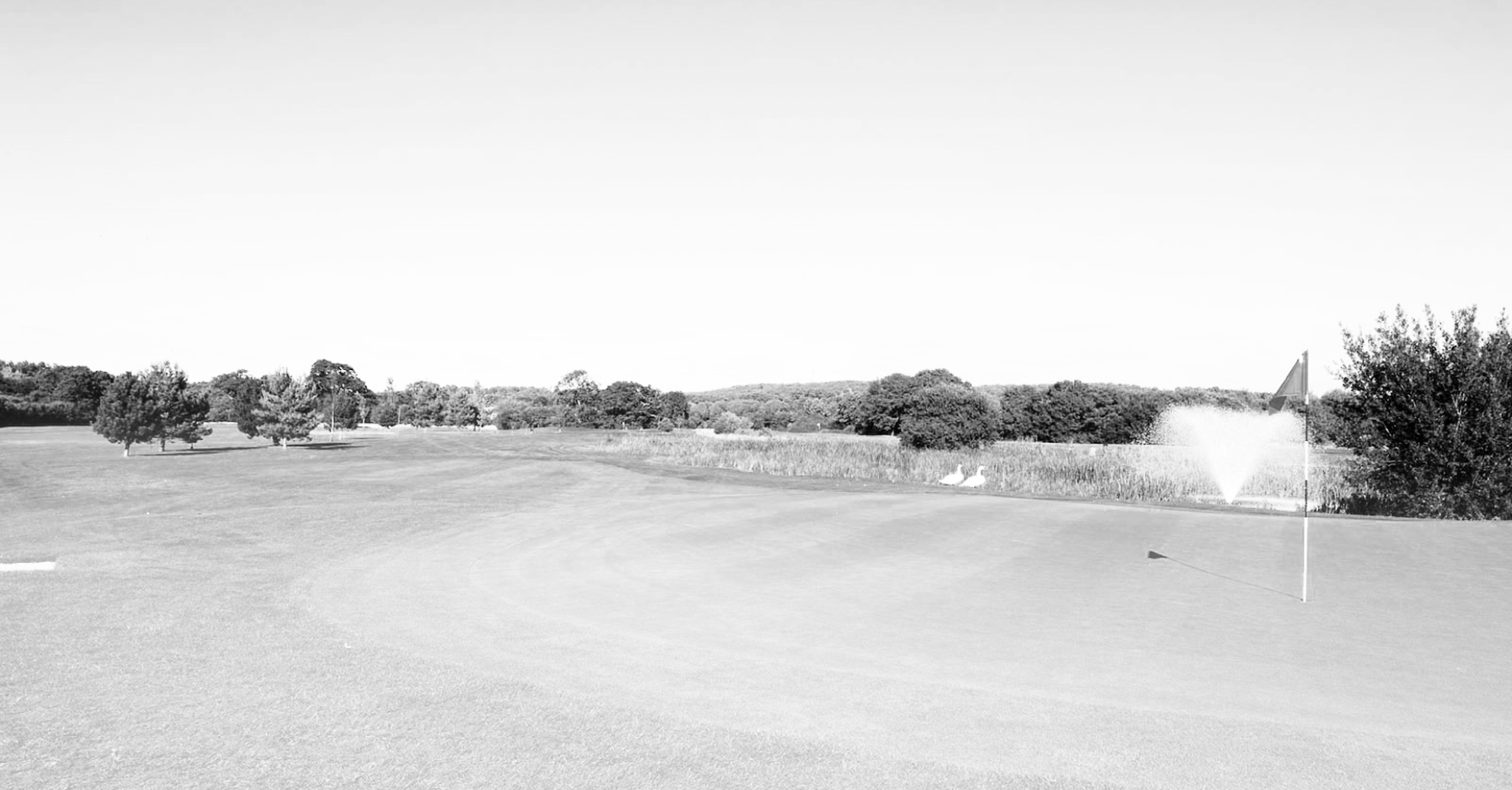 Christchurch Golf Club course - green with flag - black & white